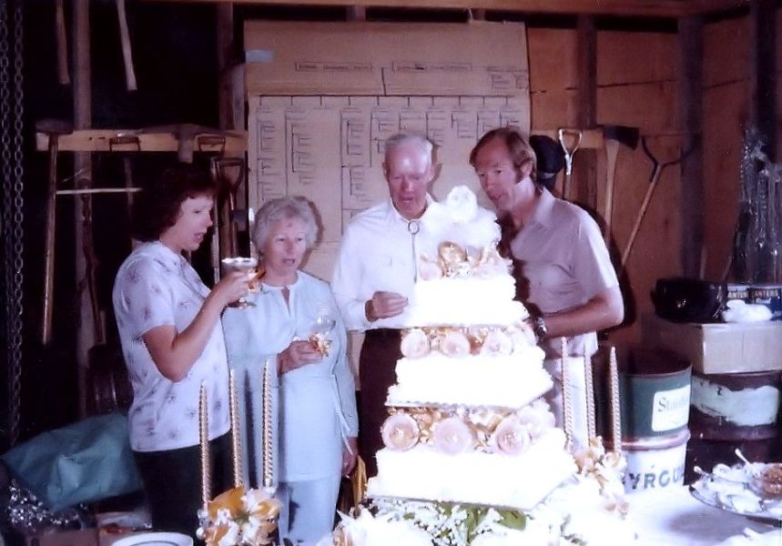 Fran, Cleo, Herman, and Fred admire their 50th Anniversary cake